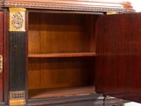 a wooden cabinet with a door open and a clock on it