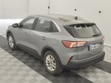 the rear end of a gray car is parked in a garage