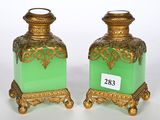 pair of green and gold vases with a price tag on each of them