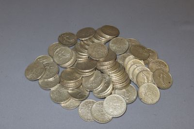 a pile of coins sitting on a table next to a pair of scissors