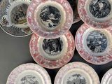 several plates with pictures of people on them sitting on a table