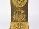 a clock that is sitting on a table with a key