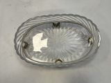 silver plate with a flower design on it on a white surface