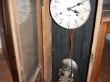a clock that is sitting in the corner of a room