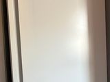 two white refrigerators in a kitchen next to each other
