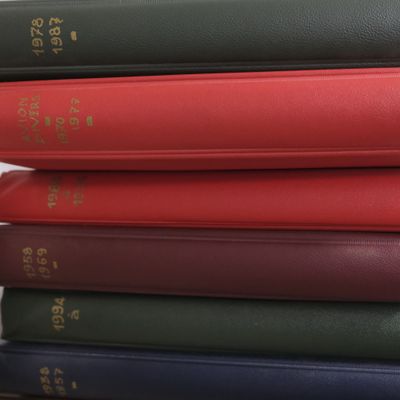 several books stacked on top of each other on a table