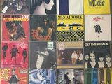 a lot of different album covers on the wall