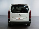 the back of a white citrole van parked in a showroom