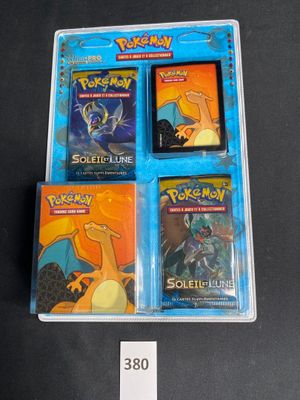 three pokemon trading cards in a plastic case on a table