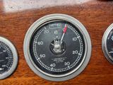three different gauges on the dashboard of a car