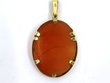 a close up of a pendant on a white surface