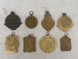 a close up of a group of medals on a white surface