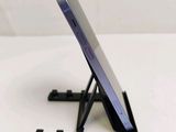 a cell phone sitting on a stand on a table