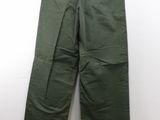 a close up of a pair of green pants hanging on a wall