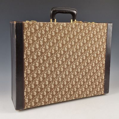 an old suitcase with a handle is sitting on a white surface