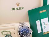 a rolex watch in a green box with a necklace