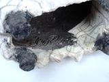 a close up of a piece of pottery with a hole in it
