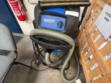 a dust collector and a chair in a room