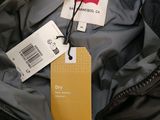 a jacket with a tag on it and a tag attached to it