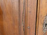 a close up of a wooden cabinet with a door handle