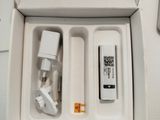 a white box with a remote and a charger inside of it