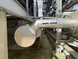 a large metal pipe in the middle of a building