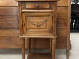 a small wooden table with a drawer on top of it