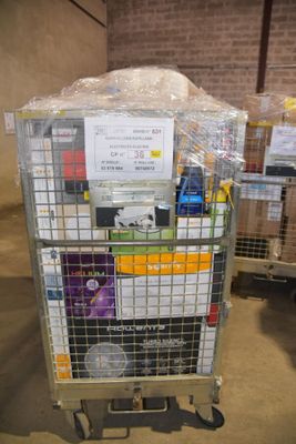 a cart with a lot of items on it in a warehouse