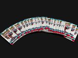 several playing cards are stacked on top of each other on a black background