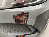 a close up of a car ' s front bumper with a sticker on it