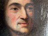 portrait of a young man in a fur coat by a mirror