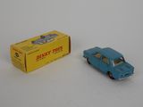 a blue toy car next to a yellow box