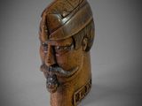 wooden head of a man with a beard and a hat