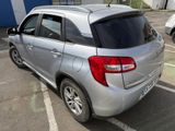 a silver car that is parked in a parking lot