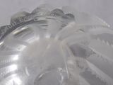 a close up of a clear glass bottle with a silver lid