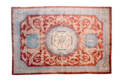 a red and blue rug with a medallion design on it