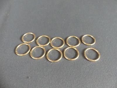 a close up of a bunch of gold rings on a table