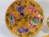 three plates that are decorated with flowers and leaves