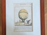 an old picture of a hot air balloon in a frame on a wooden floor