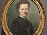 portrait of a woman in a black dress in a gold frame on a wooden easel