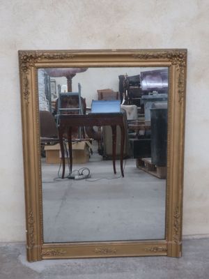 a mirror that is sitting on the floor in front of a wall