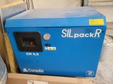 a blue compressor sitting on top of a cardboard box