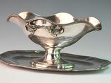 a silver plate with a bowl on it on a tray