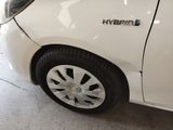 a close up of a white car with a chrome emblem on it