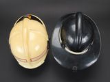 two hard hats sitting next to each other on a table
