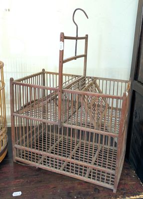 a bird cage with a bird inside of it on a table