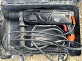 a black and orange drill in a black case