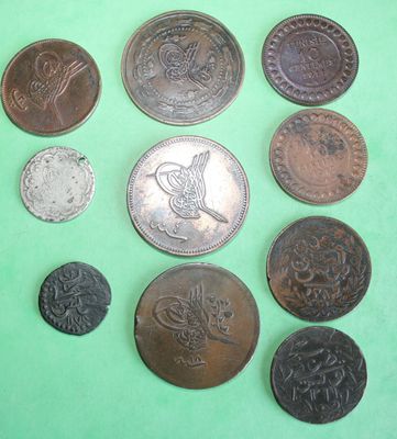 a lot of coins that are on a green surface