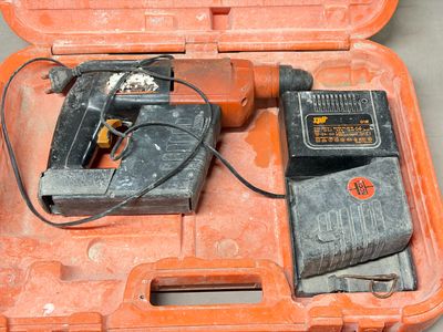 an orange case with a drill and other tools in it