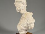 a sculpture of a woman ' s head on a wooden base